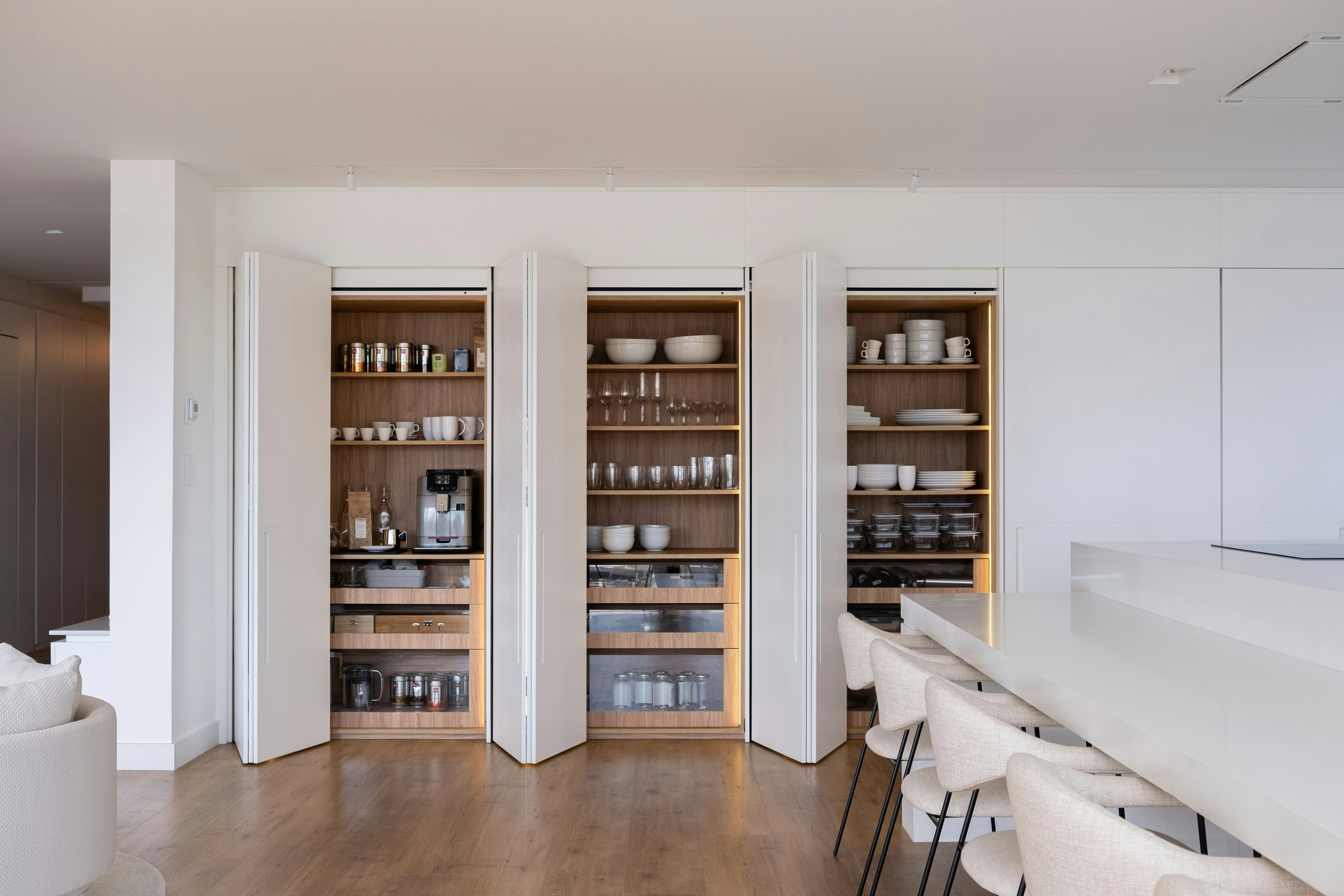 Organised kitchen storage with shelving and concealed cabinetry